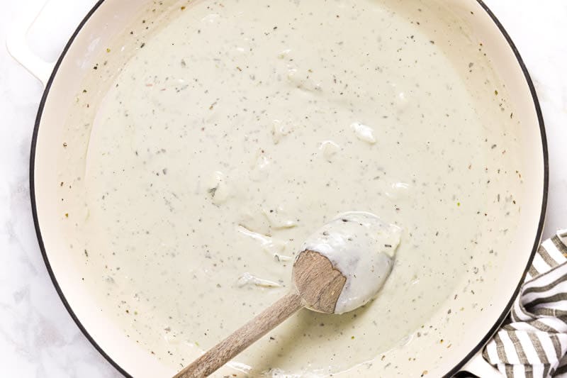 Large white pan with creamy blue cheese sauce