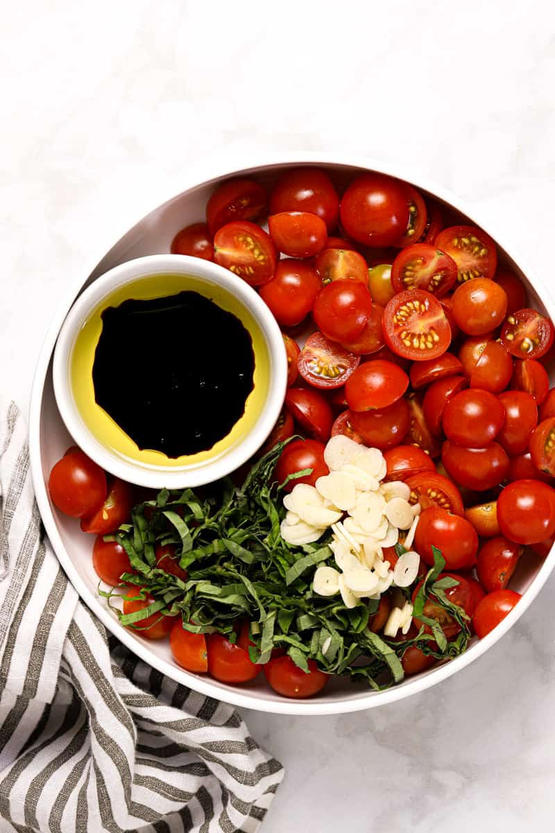 Large bowl with ingredients to make tomato bruschetta