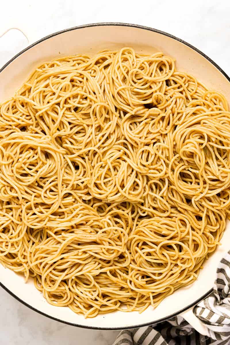 Large white pan with cooked spaghetti in it