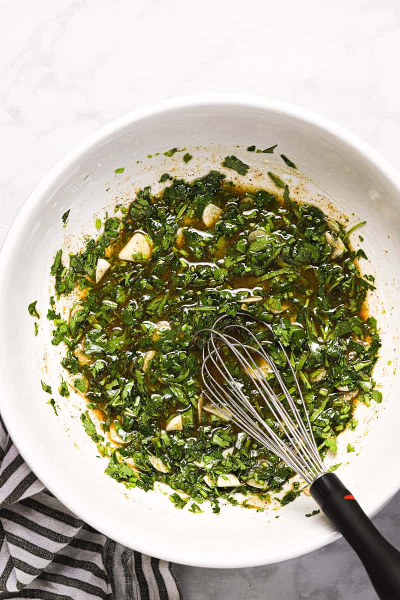 Large white bowl with cilantro lime chicken marinade