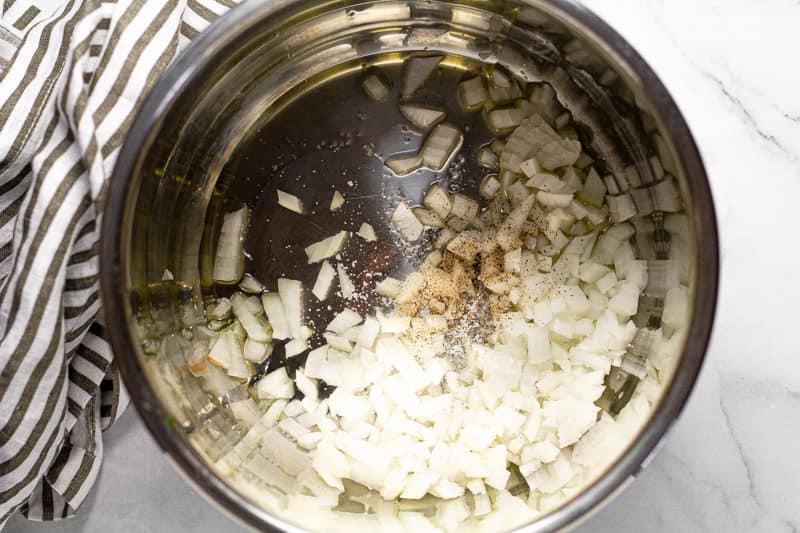 Instant pot insert with olive oil and onions
