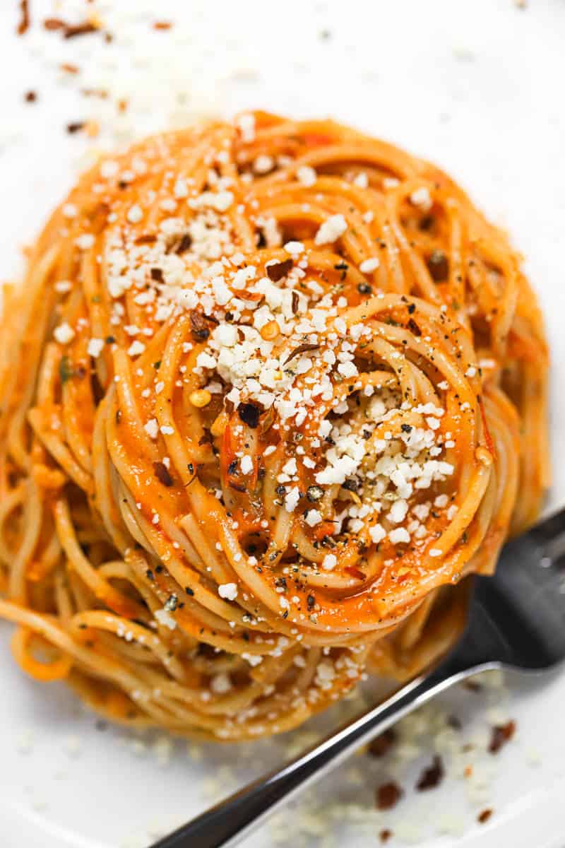 Overhead shot of a plate of spaghetti tossed in roasted tomato sauce