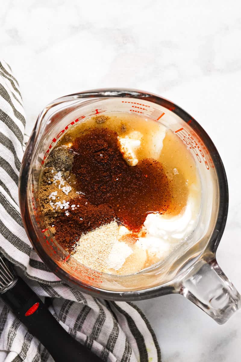 Glass measuring cup with ingredients to make creamy southwest dressing