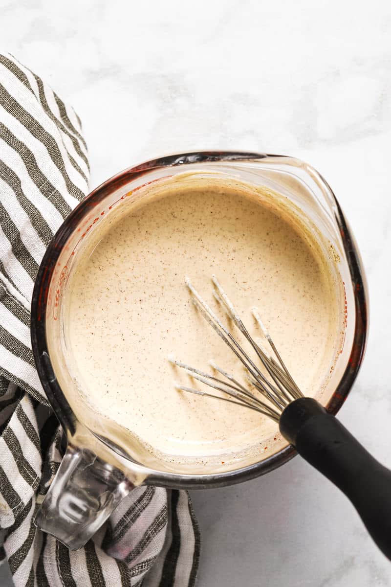 Glass measuring cup with creamy southwest dressing