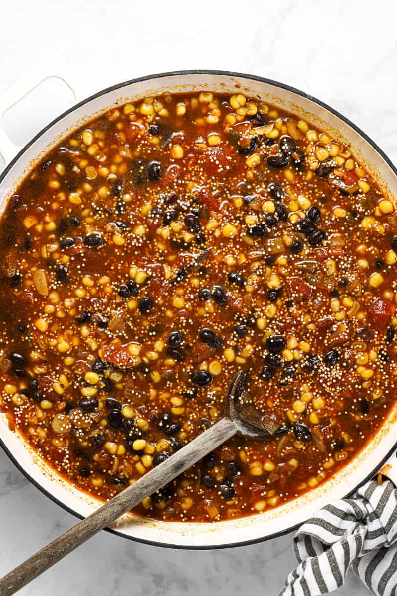 Ingredients to make Mexican quinoa in a large white pan