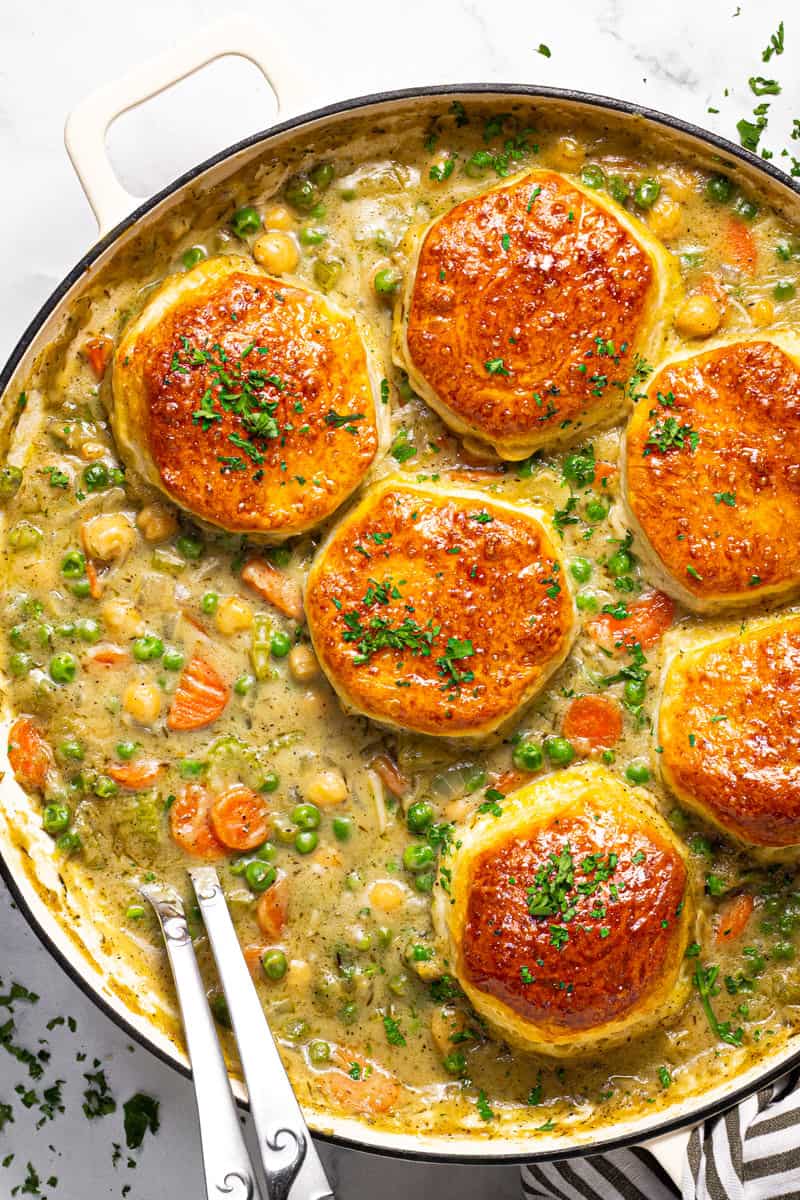 Large white skillet with homemade chickpea pot pie garnished with fresh chopped parsley 