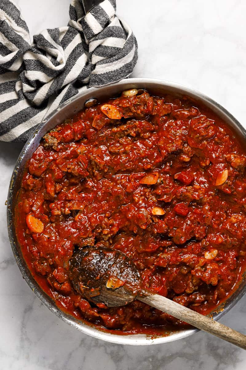 Large sauté pan filled with meat sauce for ravioli