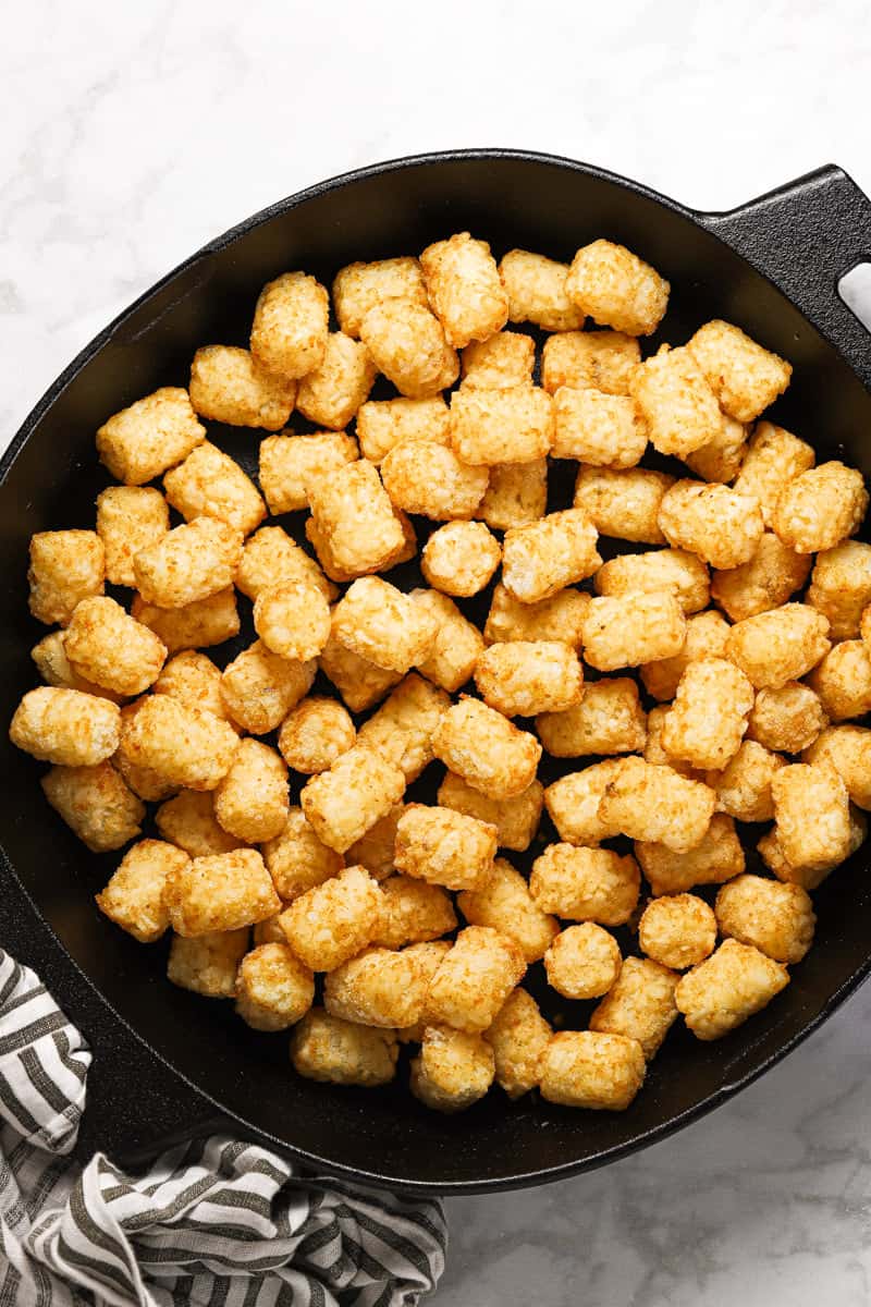 Frozen tater tots in a cast iron skillet