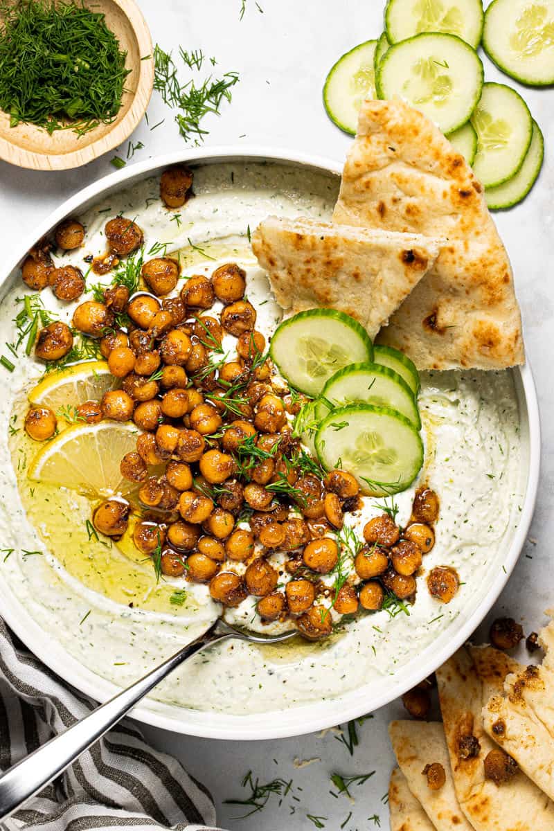 Overhead shot of a white bowl filled with whipped feta topped with chickpeas