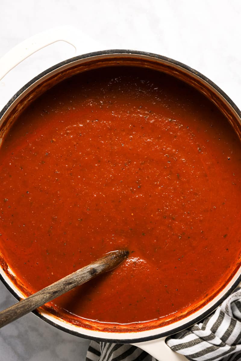 Large white pot with ingredients to make homemade tomato basil soup