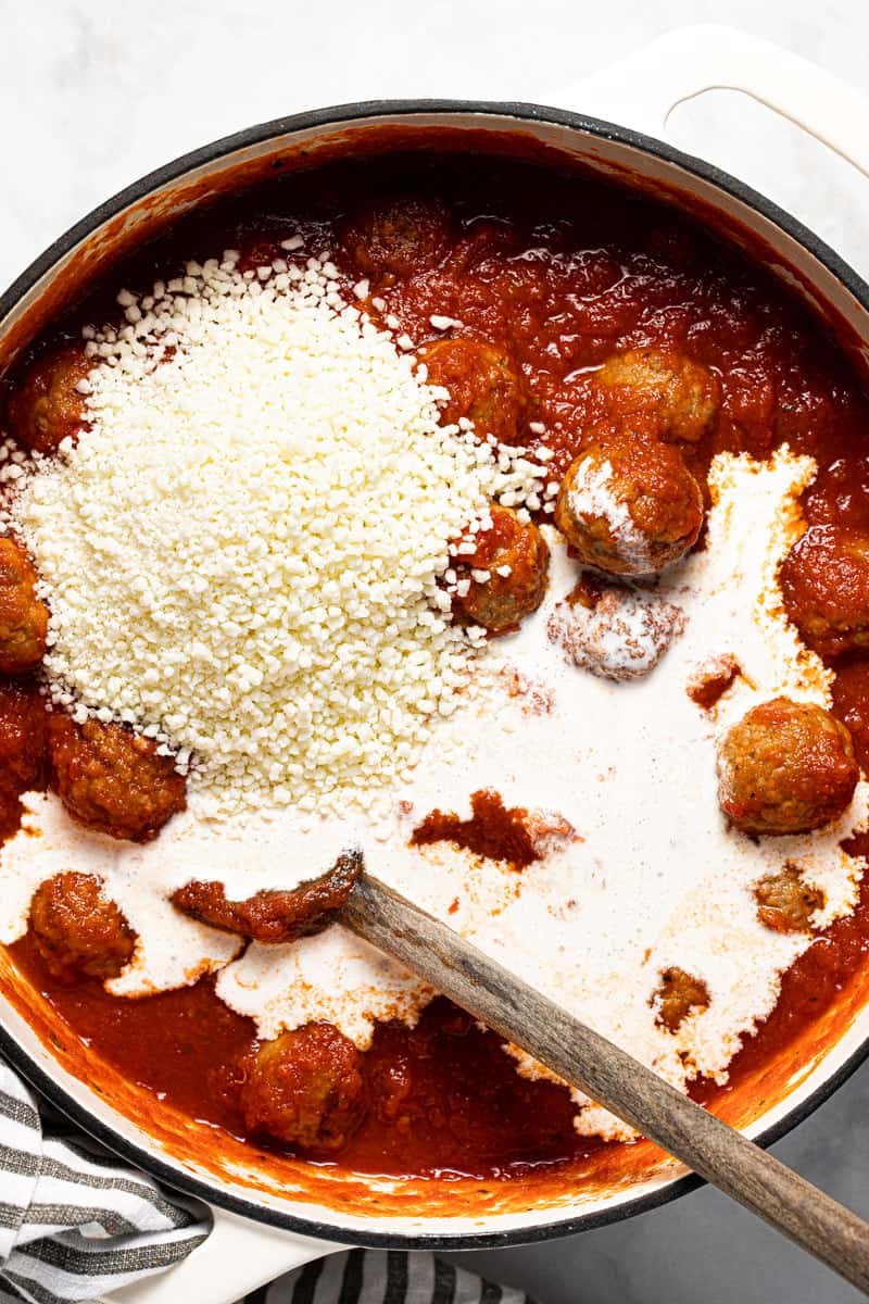 Large white pot filled with meatballs tomatoe sauce Parmesan and heavy cream