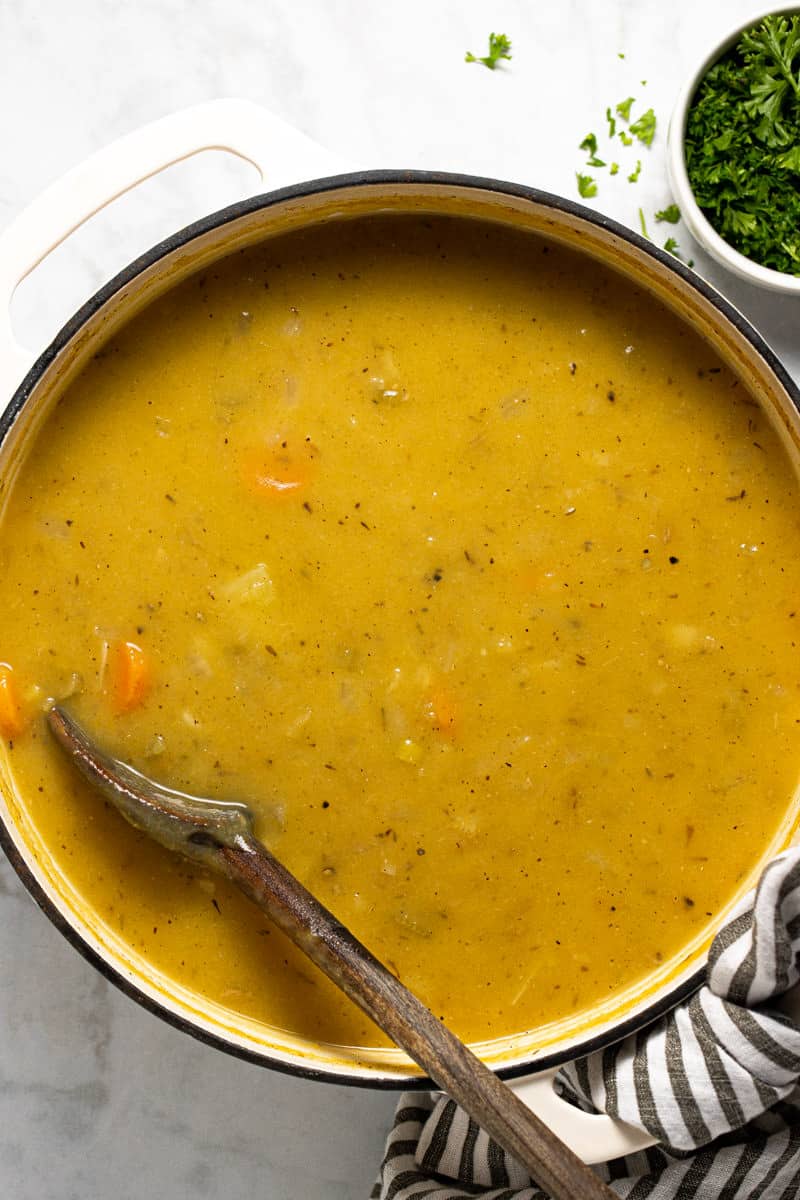 Large white pot filled with homemade vegan leek and potato soup
