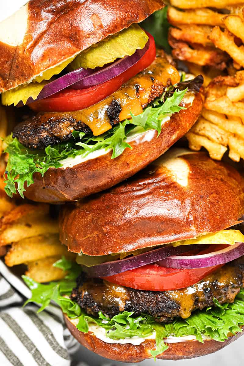 Overhead shot of a basket with two smash burgers and waffle fries in it