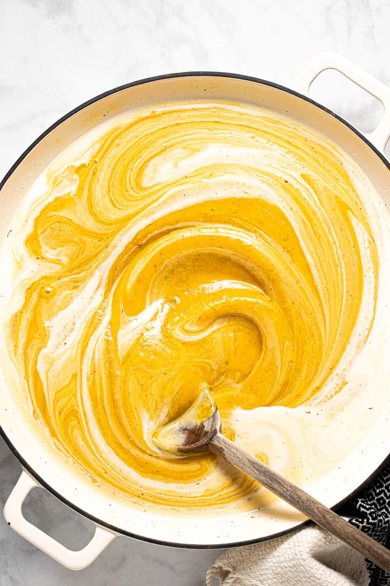 A large white pot filled with creamy roasted squash sauce