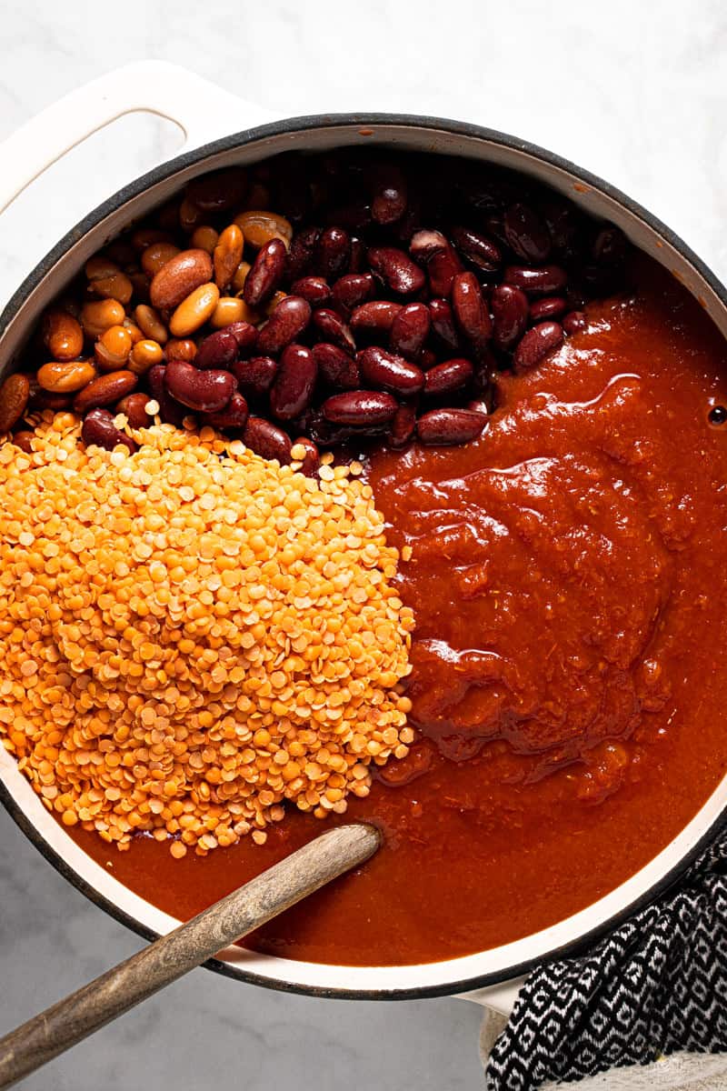 Large pot filled with ingredients to make 3 bean vegan chili