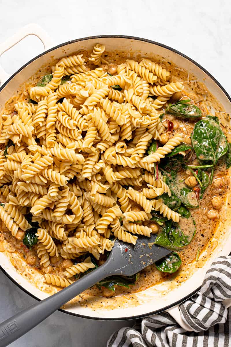 Photos showing step by step how to make creamy vegan Tuscan pasta