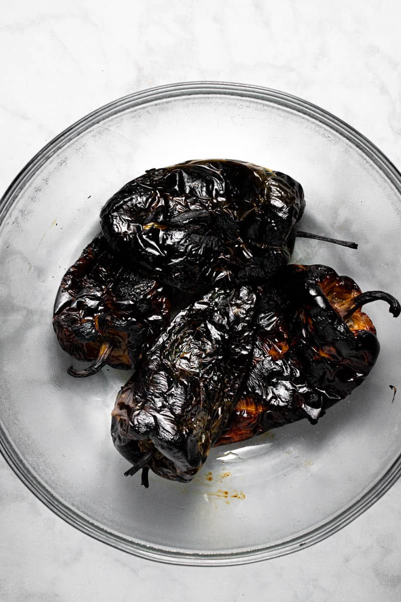 Glass bowl filled with charred peppers
