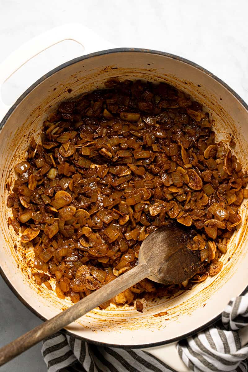 Large white pot with onion garlic and spices