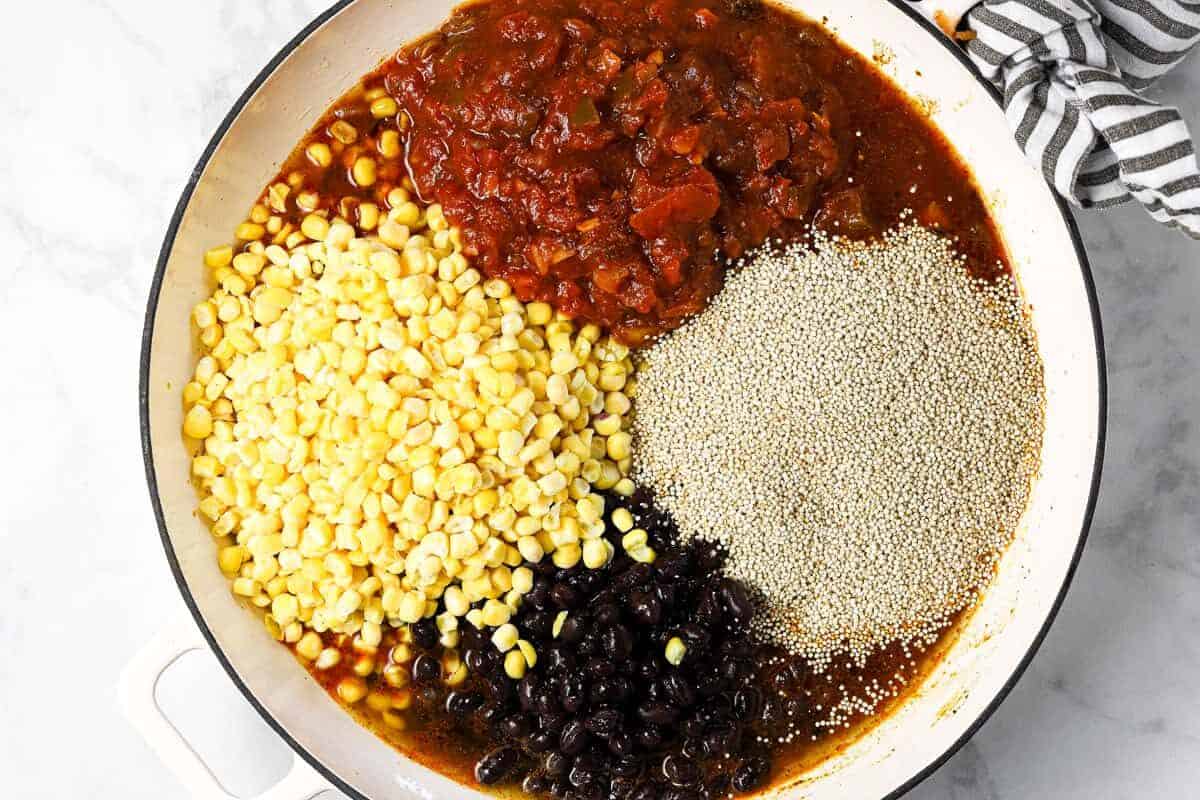 Ingredients to make Mexican quinoa in a large white pan