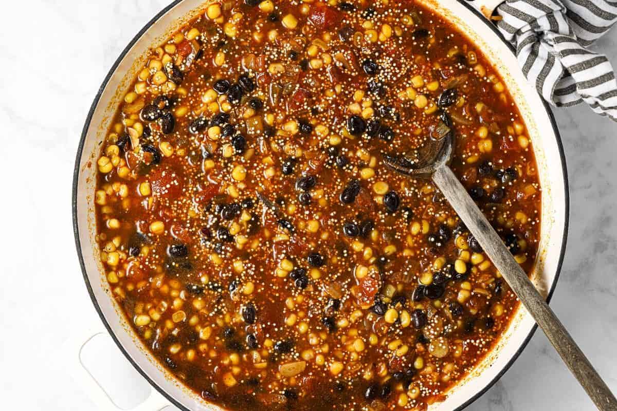 Ingredients to make Mexican quinoa in a large white pan