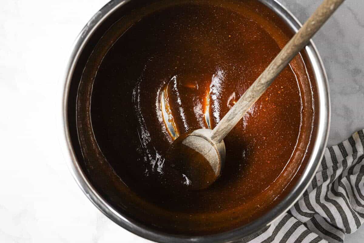 Instant pot insert with BBQ sauce and spices mixed together 