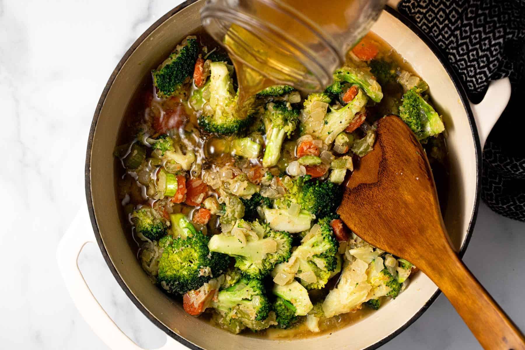 Large pot filled with ingredients to make homemade broccoli cheddar soup