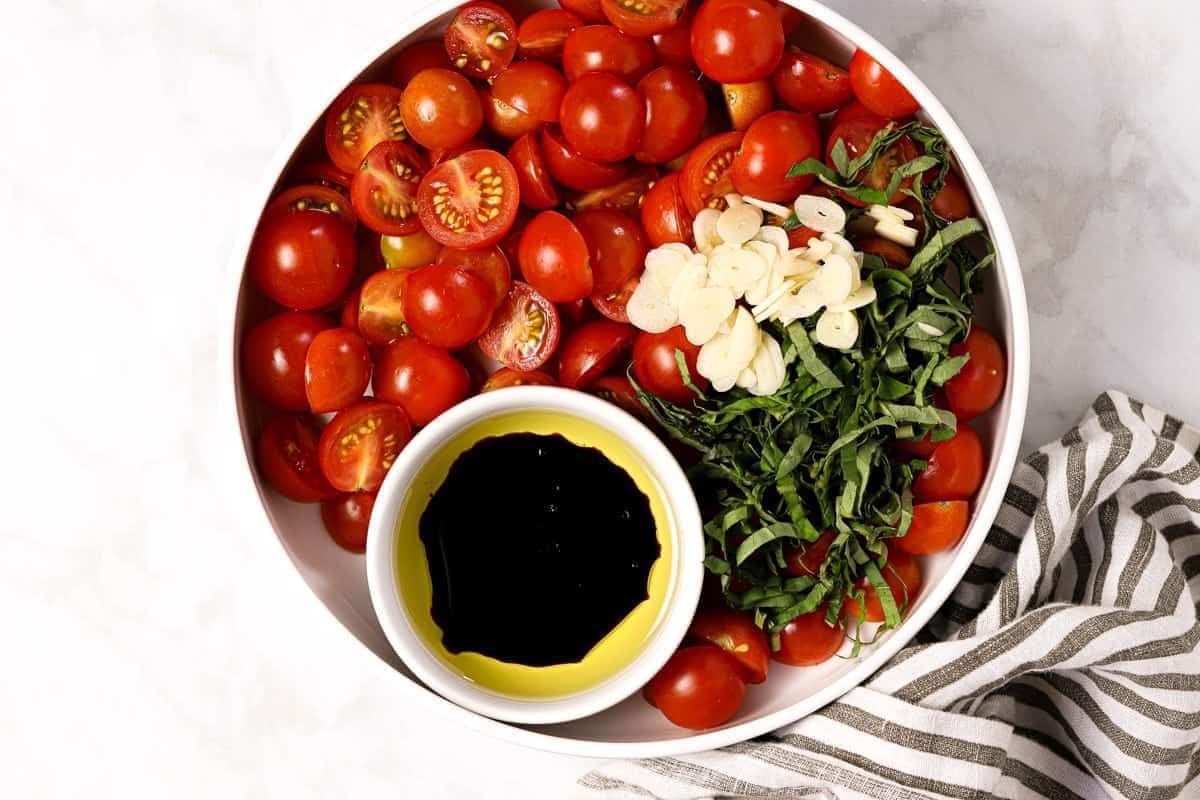 Large bowl with ingredients to make tomato bruschetta