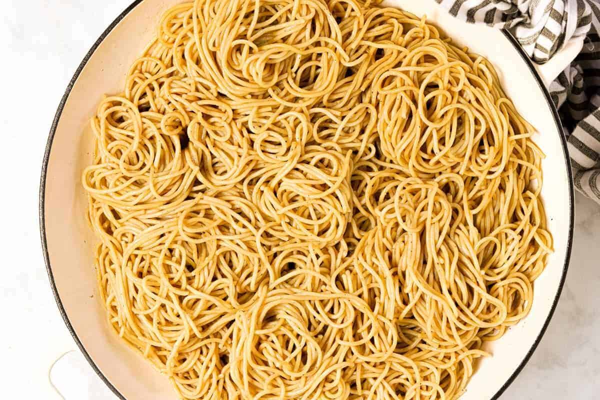 Large white pan with cooked spaghetti in it