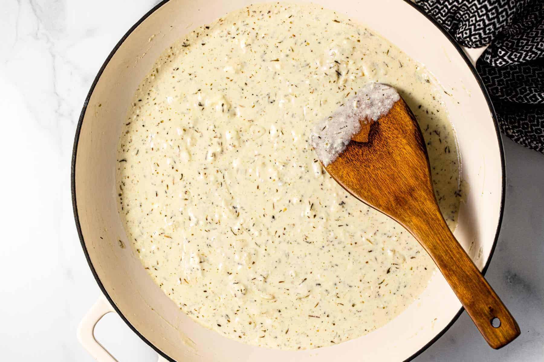 Large pan filled with creamy herb feta sauce
