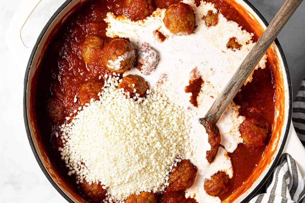 Large white pot filled with meatballs tomatoe sauce Parmesan and heavy cream
