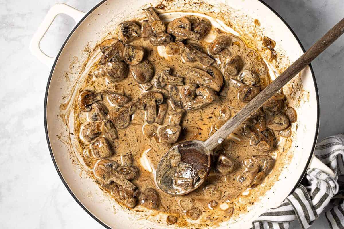 Large white pan with creamy mushroom sauce in it