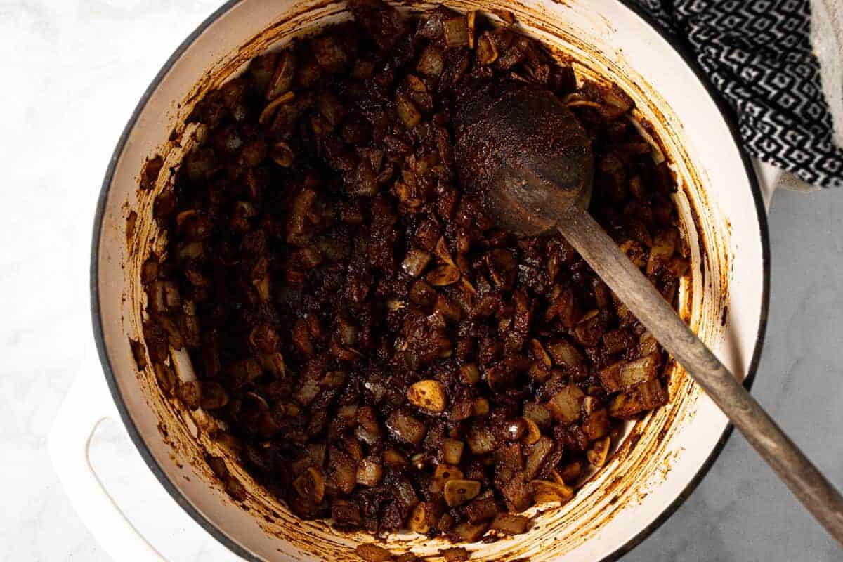 Large pot filled with ingredients to make 3 bean vegan chili 