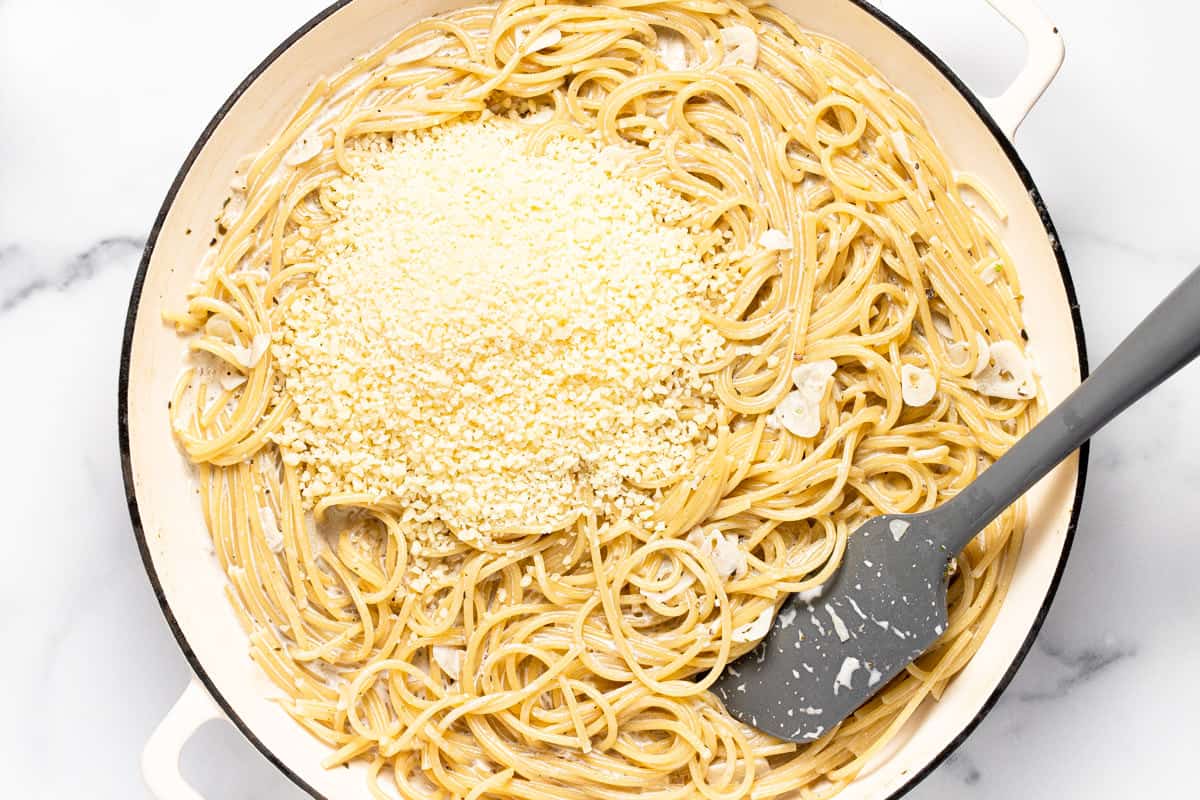 Large white pan filled with ingredients to make garlic Parmesan pasta