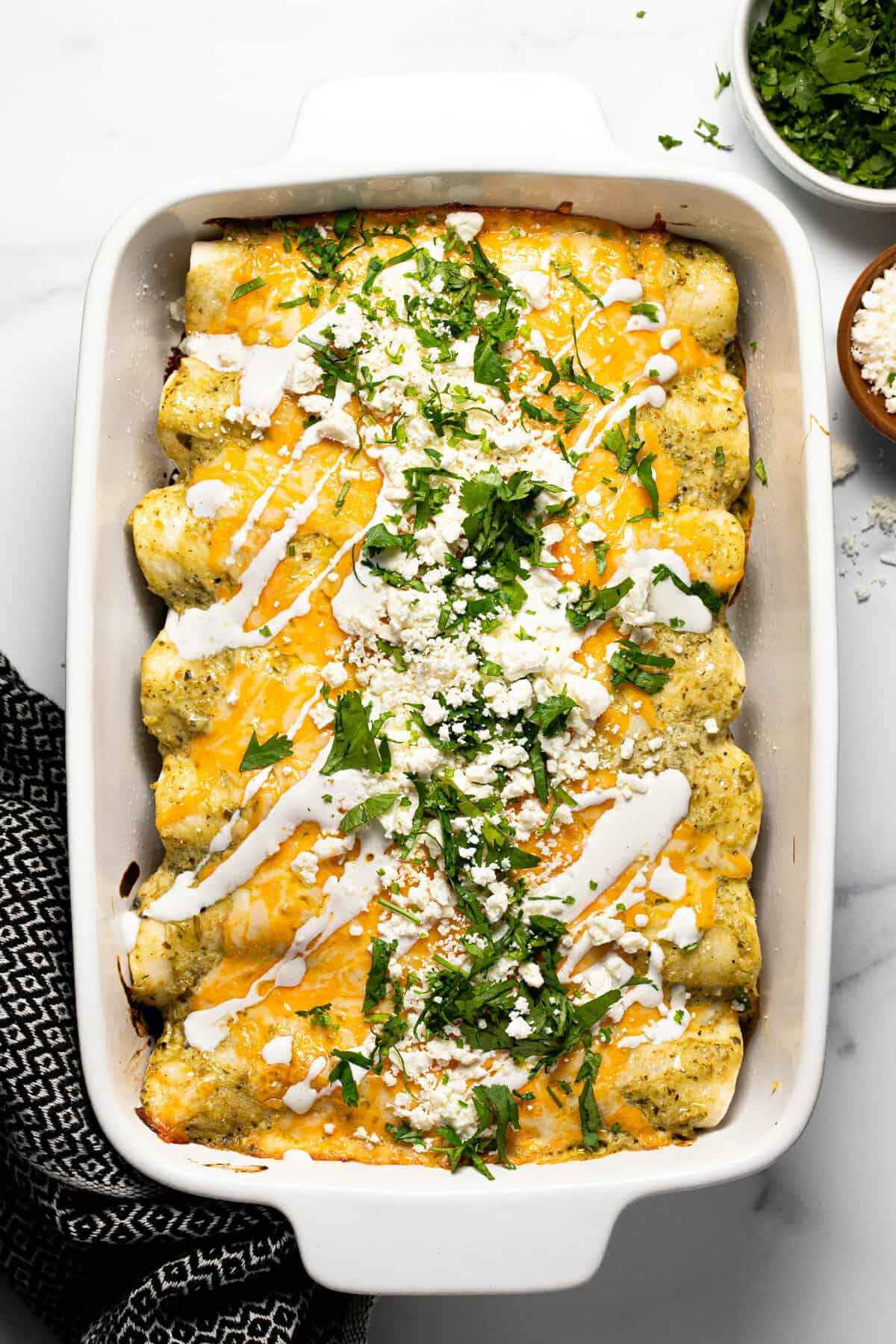 White baking dish filled with pulled pork carnitas enchiladas