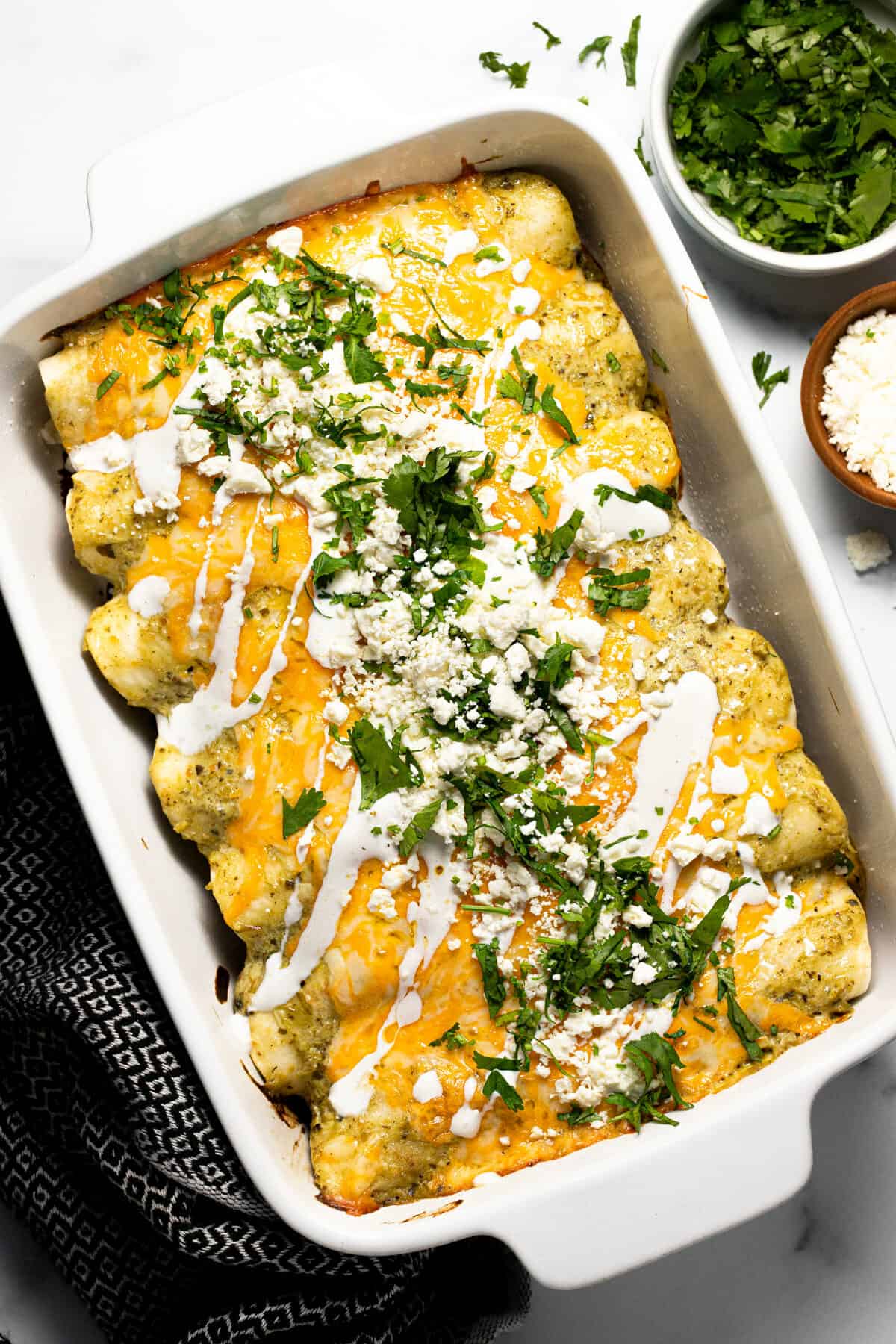 White baking dish filled with pulled pork carnitas enchiladas