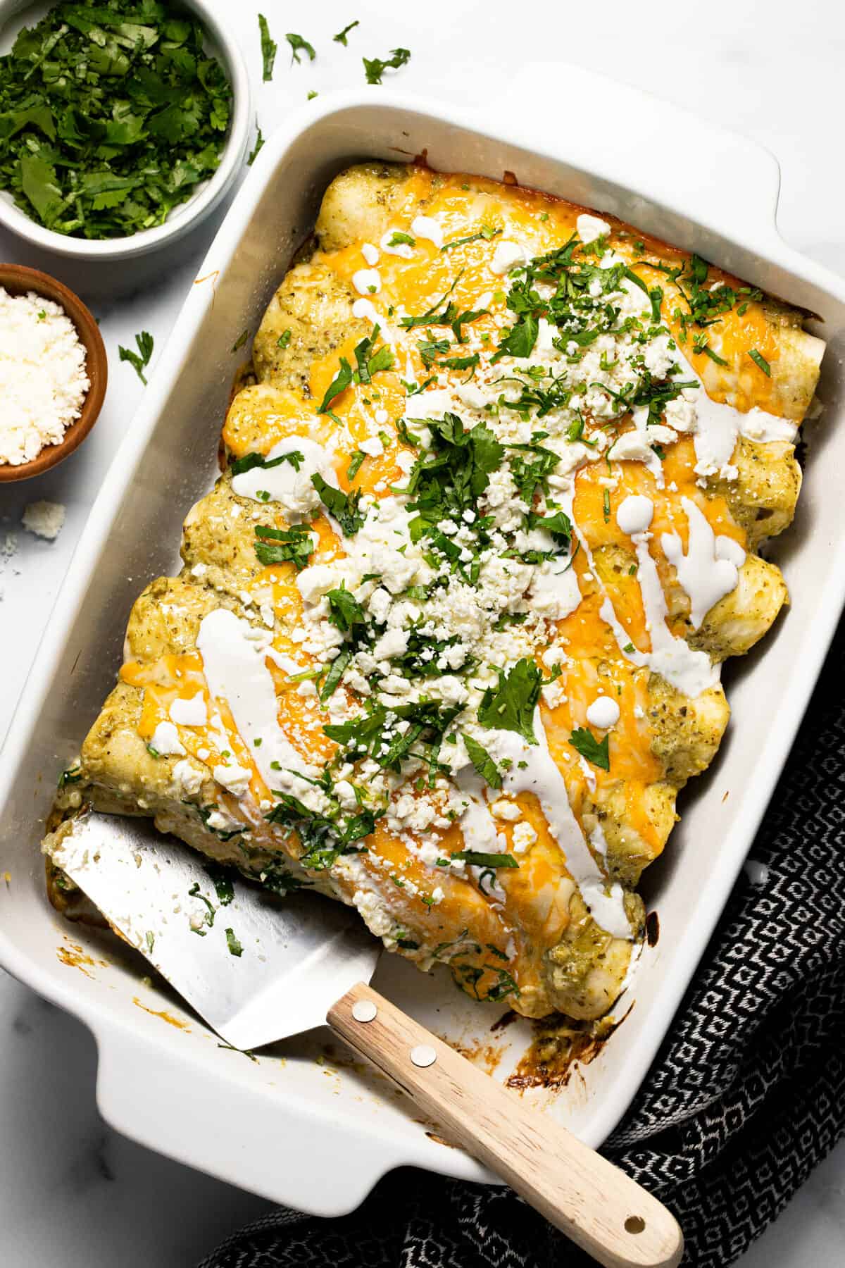 White baking dish filled with pulled pork carnitas enchiladas