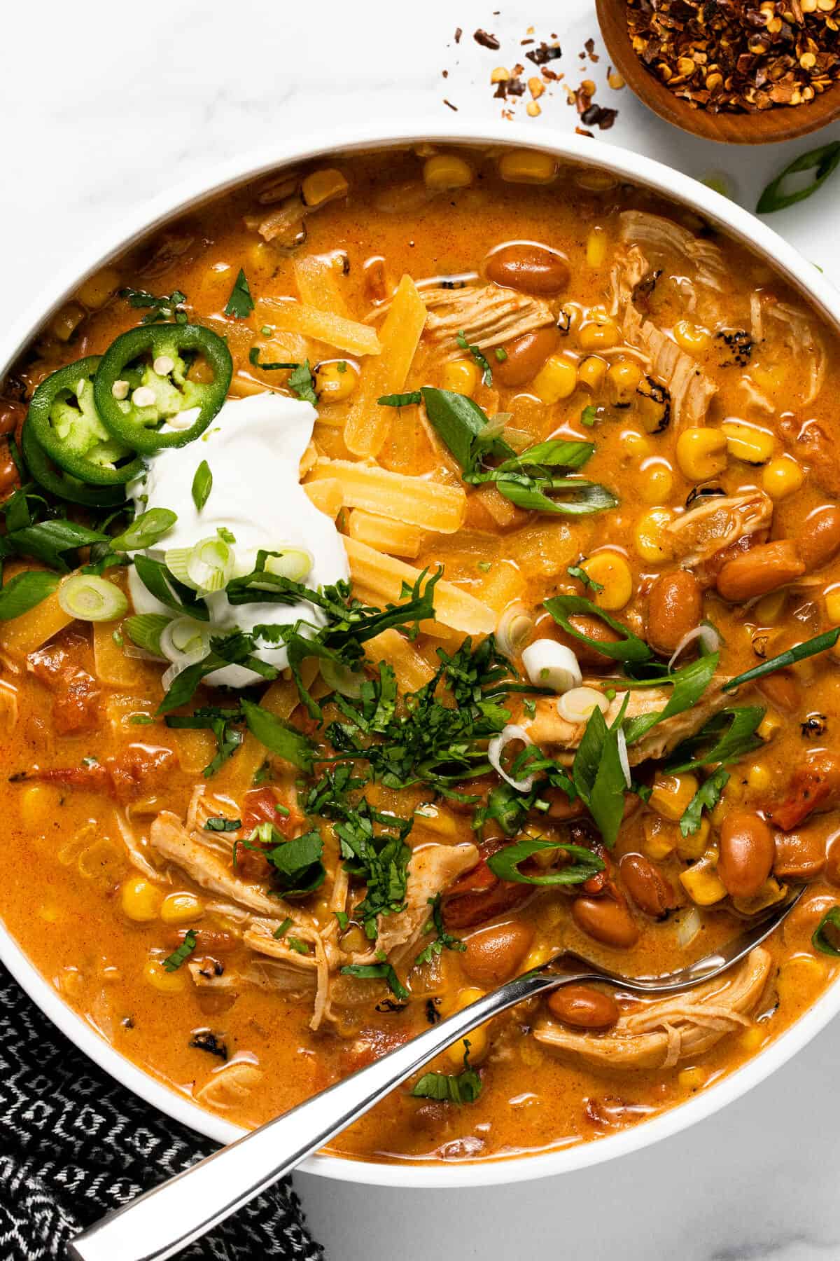 Large white bowl filled with creamy instant pot chicken chili