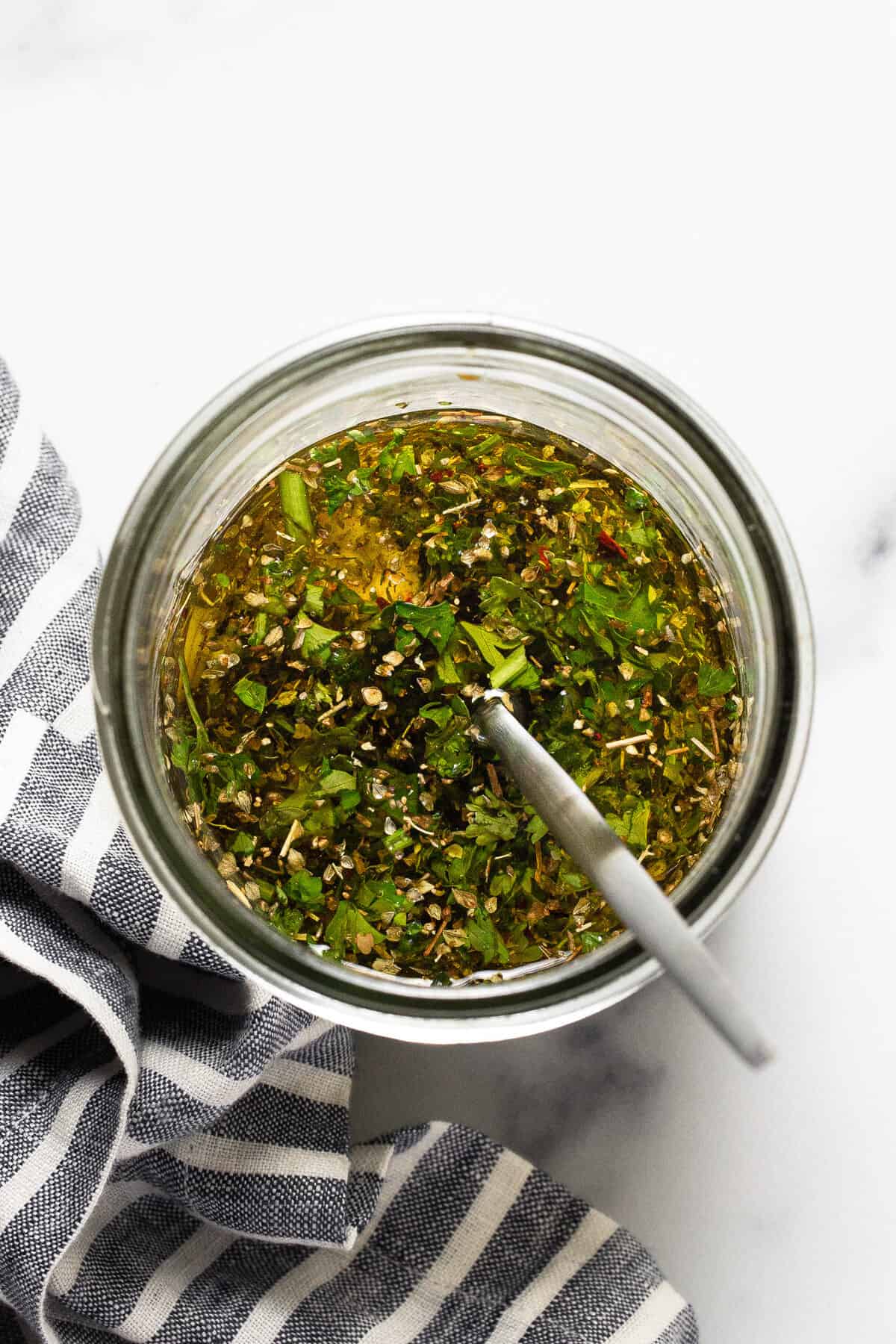 Mason jar filled with an herby feta marinade