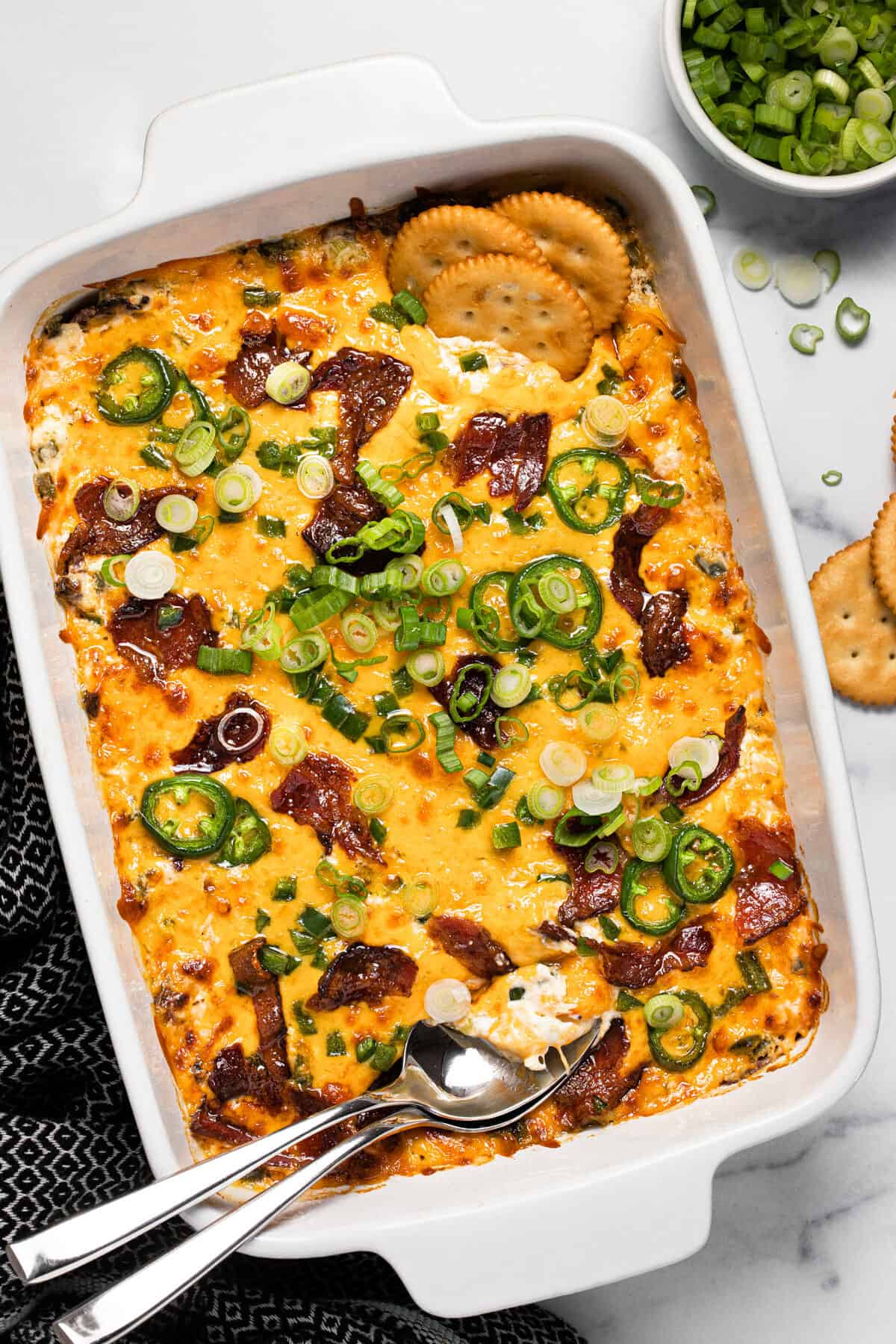 Large white baking dish filled with homemade jalapeno popper dip