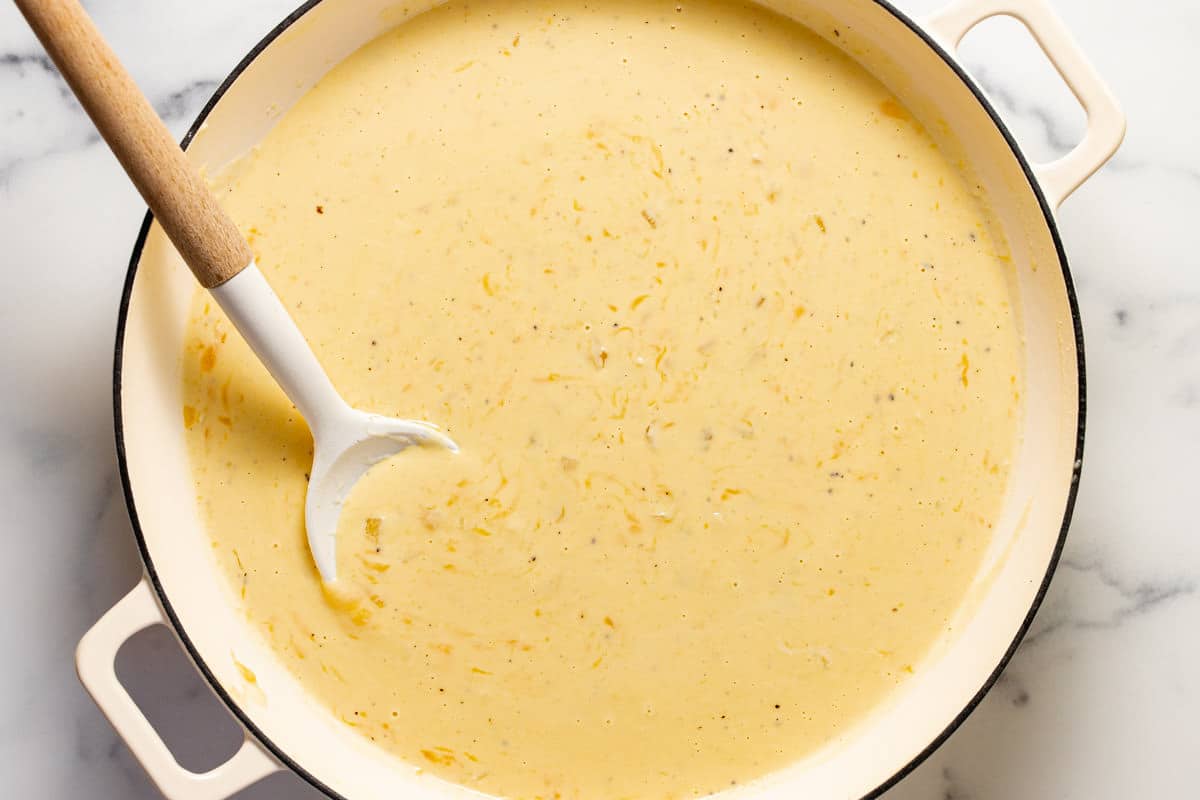 White pan filled with creamy cheese sauce