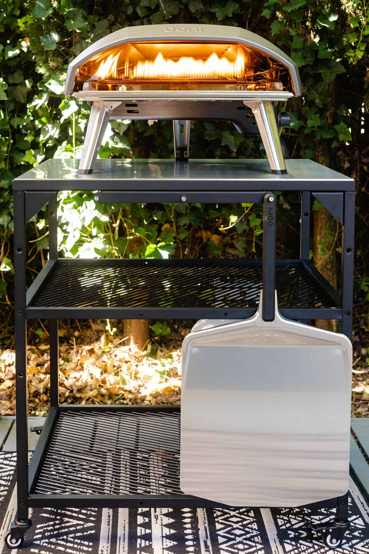 Ooni pizza oven on a metal table outside on a deck