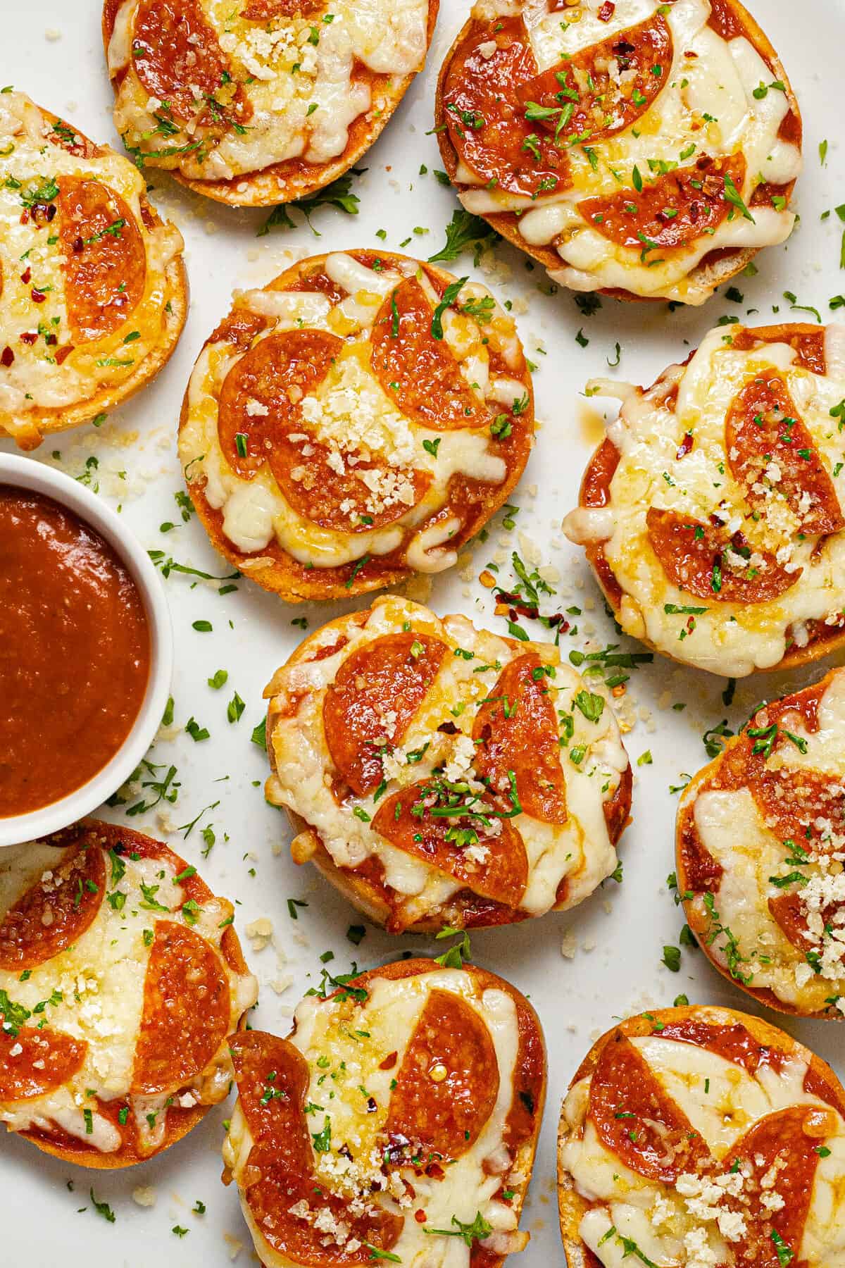Close up shot of homemade pizza bagel bites garnished with parsley