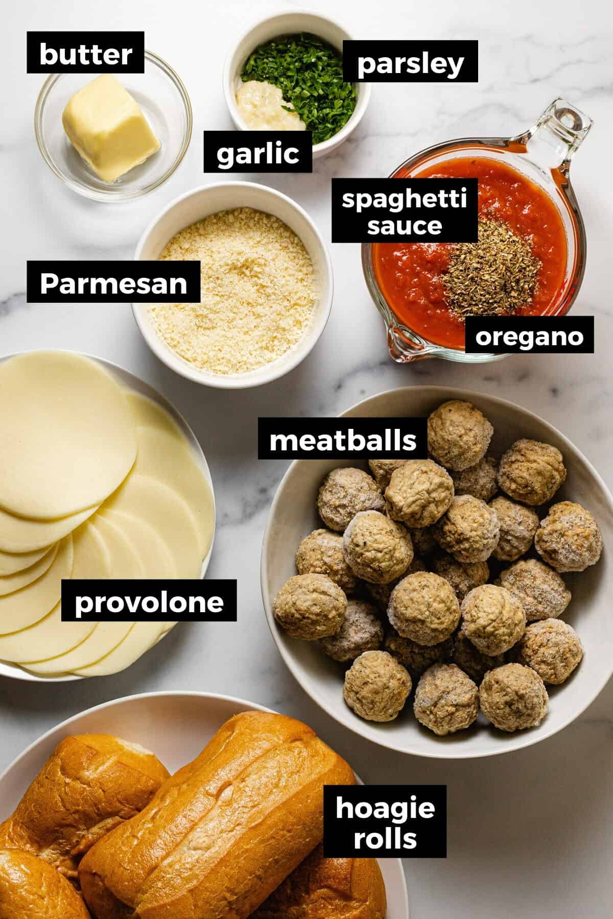 White marble counter top filled with ingredients to make easy homemade meatball sandwiches