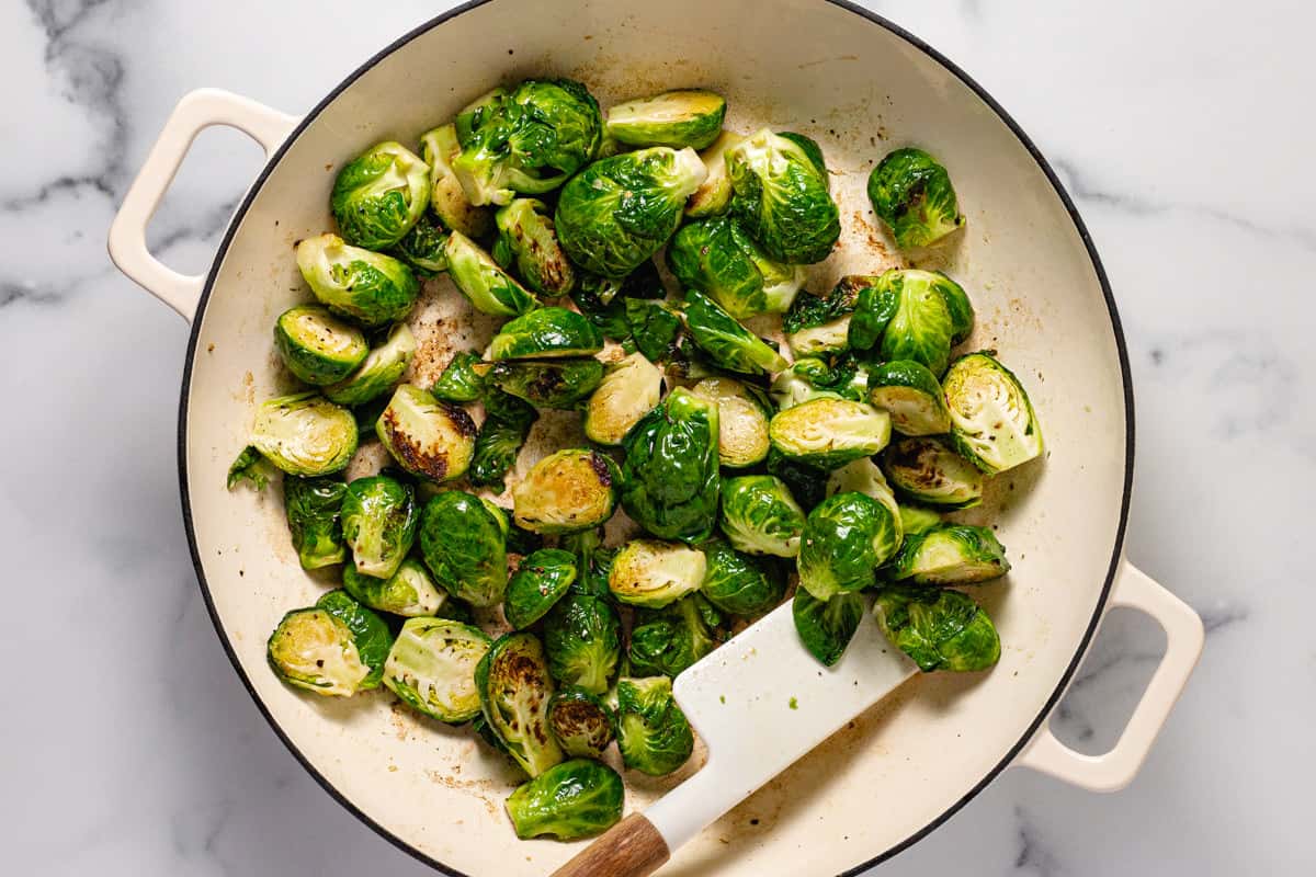 Large white pan filled with sautéed Brussel sprouts