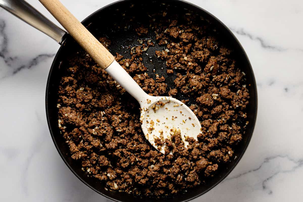 Browned ground beef and garlic in a large sauté pan