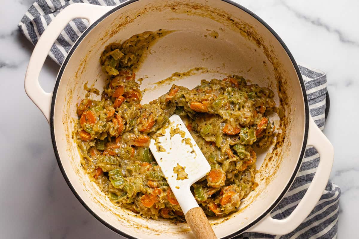 Large white pot filled with sautéed veggies in a roux of flour and butter