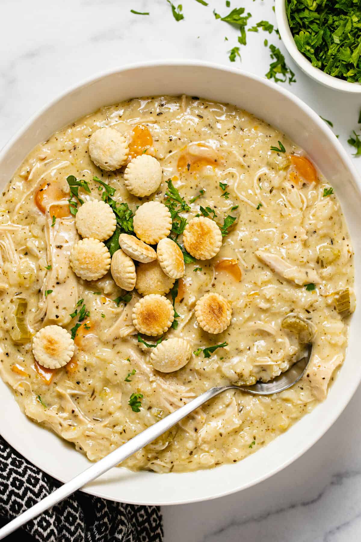 Large white bowl filled with creamy instant pot chicken and rice soup