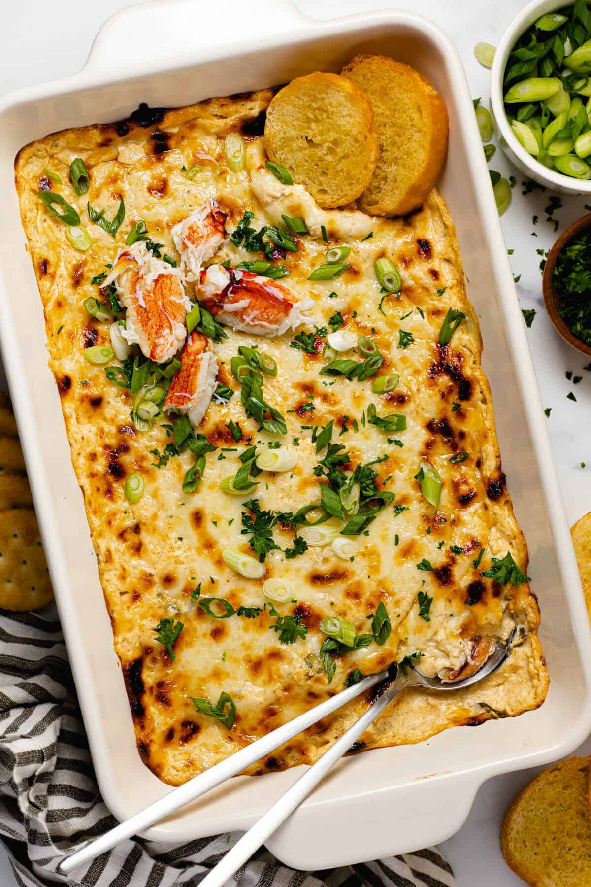Large white baking dish filled with creamy homemade baked crab dip