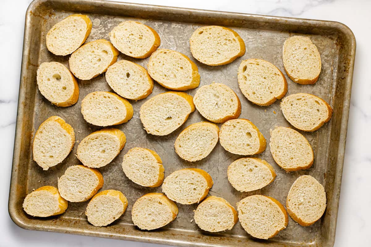 Sliced French bread on a baking sheet