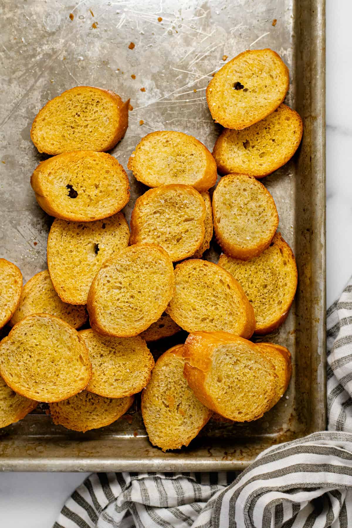 A baking sheet filled with crispy homemade crostini